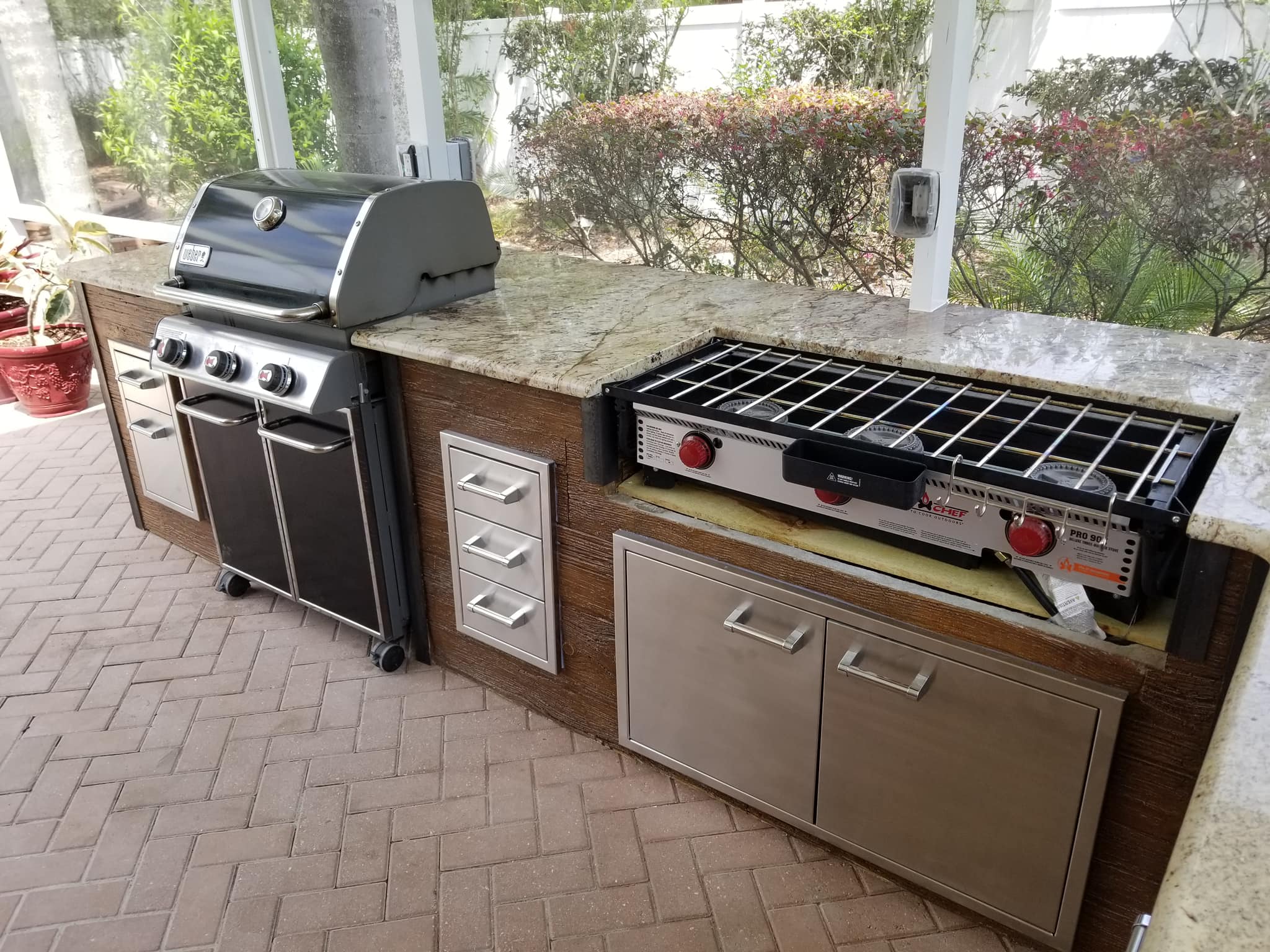 Custom Outdoor Kitchen Installation with Grill, Stove, Countertops, and Wooden Cabinets in Lakeland, FL
